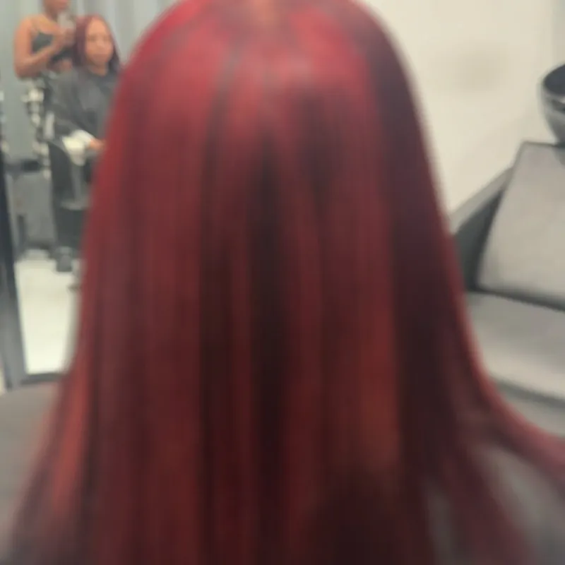 Sleek deep red hair, straightened and shining